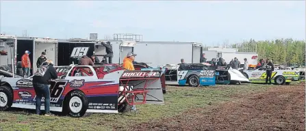  ??  ?? The pit area at New Humberston­e Speedway in Port Colborne becomes a beehive of activity after race cars are unloaded from their haulers.