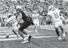  ?? CHUCK BURTON AP ?? Clemson cornerback Nate Wiggins (20) knocks down a fourth down pass intended for Wake Forest wide receiver A.T. Perry (9) during the second overtime Saturday in Winston-Salem, North Carolina, giving the Tigers the victory.