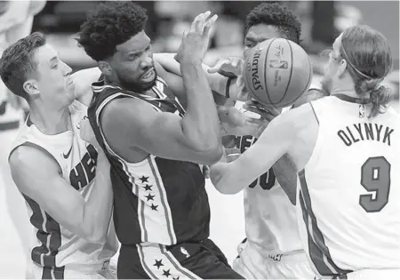  ?? SZAGOLA/AP ?? Philadelph­ia’s Joel Embiid works in traffic Tuesday night against the Heat.CHRIS