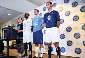  ?? STAFF PHOTO BY TIM BARBER ?? Paul Rustand, left, introduces Chattanoog­a Football Club players, from left, Chris Ochieng, John “Snoop” Davidson and Sias Reyneke in the team’s new uniforms for the 2015 season Thursday at Finley Stadium.