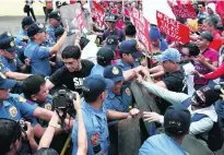  ?? Rolex Dela Pena / EPA ?? Protesters scuffle with police during a rally to mark the 31st anniversar­y of a pro-democracy revolution.