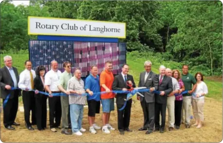  ??  ?? Helping to cut the ribbon of a new electric sign, a gift from the Langhorne Rotary Club, are, from left. Larry Brynes, site design, Chadrow Associates; Dan Schaffer, CEO, First National Bank and Trust of Newtown; Connie Furman, senior vice president,...