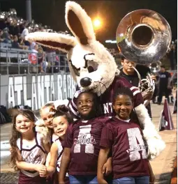  ?? Staff photo by Neil Abeles ?? ■ One of the Atlanta Rabbit’s most important duties—and most fun, the rabbit says— is to play with the children along the sidelines at Rabbit football games.