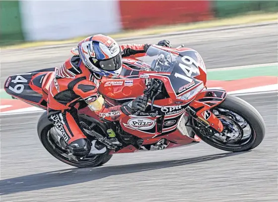  ??  ?? An AP Honda Thailand team rider in action at Suzuka Circuit.