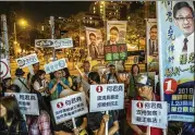  ?? LAM YIK FEI / NEW YORK TIMES ?? Volunteers campaign Saturday during district council elections in the Tuen Mun neighborho­od of Hong Kong.