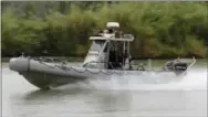  ?? THE ASSOCIATED PRESS ?? A Texas Parks and Wildlife boat patrols along the Rio Grande near Granjeno, Texas.