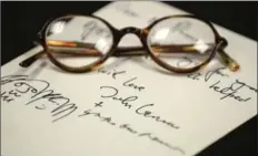  ?? HAMILTON SPECTATOR FILE PHOTO ?? Above right: The archive has a Christmas card from John Lennon and Yoko Ono, written to Bertrand Russell. That is a pair of Russell’s glasses on the card.