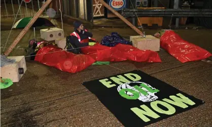  ?? ?? Protesters blocking an Esso West oil facility near Heathrow on Monday. Photograph: Andrea Domeniconi/Extinction Rebellion/PA