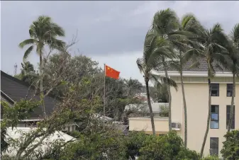  ?? Mark Baker / Associated Press ?? A Chinese flag flies at the Chinese Embassy in Nuku'alofa, Tonga. Beijing is pouring billions of dollars in aid and loans into the kingdom of 106,000 people, equivalent to 25% of its GDP.