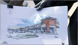  ??  ?? Rob Seidel of S2 Capital Partners shows one of the architect’s renderings of what the Bryans Road Shopping Center will look like this September.