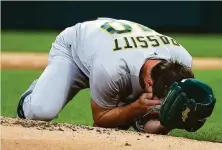  ?? Erin Hooley / TNS ?? A’s starting pitcher Chris Bassitt holds his hands to his face after getting hit by a line drive on Tuesday night in Chicago.