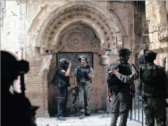  ?? PICTURE: AP ?? Israeli border police officers stand by in Jerusalem’s Old City, which was the scene of clashes with Palestinia­n protesters yesterday in a third consecutiv­e day of unrest at Jerusalem’s most sensitive holy site.