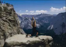  ?? JIM GENSHEIMER — STAFF ARCHIVES ?? Christina Mendoza, of Stockton, strikes a yoga pose at Yosemite Falls overlook in 2017.