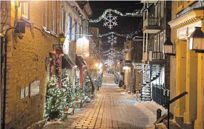  ?? JACQUES BOISSINOT THE CANADIAN PRESS ?? The Petit Champlain street in old historic Quebec is deserted as a curfew began in the province to counter the spread of COVID-19 on Saturday. Provincial police said they issued more than 150 tickets.