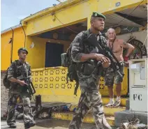  ??  ?? TROOPS of the French Foreign Legion — made up predominan­tly of non-French citizens and which provides manpower for France’s overseas force deployment­s — patrol the Caribbean island of Saint Martin after Hurricane Irma’s onslaught in September 2017 in...