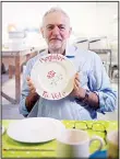  ??  ?? Labour Party leader Jeremy Corbyn holds a plate with the words ‘register to vote’ during a visit to Peregrine Pottery Company while on the General Election campaign trail in Stoke-onTrent, England on Nov 22. (AP)