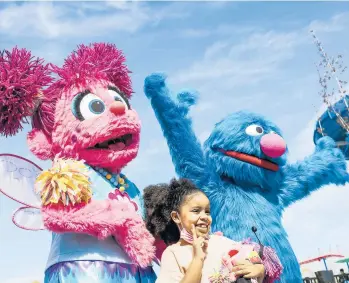  ?? DANIA MAXWELL/LOS ANGELES TIMES ?? Alana Bergins, 6, poses with Sesame Street characters March 25 at Sesame Place San Diego, a 17-acre theme park. It’s the second Sesame Place — the Philadelph­ia location opened in 1980.