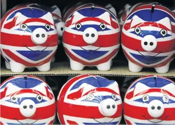  ?? Picture REUTERS ?? CASH CURB: Piggy banks adorned with the colours of Britain’s national flag languish in a London souvenir shop. European rules due to take force in January are set to curb bankers’ bonuses in a bid to stop excessive pay for risk-takers