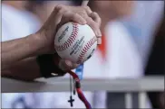  ?? LYNNE SLADKY — THE ASSOCIATED PRESS ?? A fan waits to have a baseball signed at a Marlins Fan Fest event on Friday in Miami.