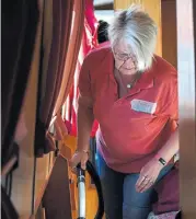  ?? ?? Cath Preedy hard at work vacuuming in the confines of a narrowboat passageway.