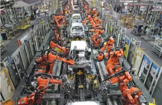  ?? REUTERS ?? FORD CARS are assembled at a plant of Ford India in Chengalpat­tu, on the outskirts of Chennai, India, March 5, 2012.