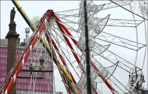  ??  ?? The big wheel was under constructi­on in George Square as it gets set to form part of the Christmas attraction­s in the city Picture: Colin Mearns