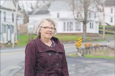  ?? ANDREW VAUGHAN/THE CANADIAN PRESS ?? Trudy Thompson, chairwoman of the Chignecto Central Regional School Board, stands on the highway in Maitland, N.S. on Wednesday. Rural classrooms across Atlantic Canada have been gutted by a demographi­c squeeze of low birth rates, youth outmigrati­on...