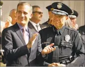  ?? Al Seib Los Angeles Times ?? L.A. POLICE CHIEF Michel Moore, with Mayor Eric Garcetti, got a $1.27-million DROP payout.