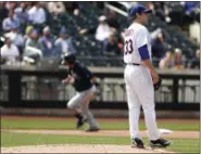  ?? FRANK FRANKLIN — ASSOCIATED PRESS ?? Mets pitcher Matt Harvey reacts as Braves’ Kurt Suzuki runs the bases after hitting a three-run homer in the fifth inning of Thursday’s game.