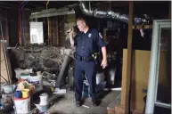  ?? Hearst Connecticu­t Media file photos ?? Danbury police officer Ken Utter, of Danbury’s Unified Neighborho­od Inspection Team checks out an abandoned property on Morris Street July 15, 2014. Utter was suspended for eight days following an internal investigat­ion of an June 2021 incident at Danbury Library. This was the first time he was discipline­d in his 25-year career with Danbury Police Department.