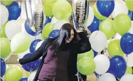  ?? IAN KUCERAK / POSTMEDIA ?? Robin Walker celebrates at a news conference at the Alberta Gaming and Liquor Commission headquarte­rs in St. Albert on Wednesday. She and her husband won $60 million in the Sept. 22 draw.