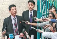  ?? MOHD RASFAN / AFP ?? DPRK diplomat Ri Tong-il (left) addresses journalist­s outside the country’s embassy in Kuala Lumpur on Thursday.