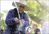  ?? THE CALIFORNIA­N ?? In this 2017 file photo, Heike Duran, a graphic artist at the Kern County Public Health Services Department, rinses her eyes from a hose during a pesticide overspray training exercise near Wasco.