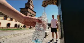  ?? Luca Bruno/Associated Press ?? Tourists fill plastic bottles with water from a public fountain at the Sforzesco Castle, in Milan, Italy, June 25, 2022. A new study found the average liter of bottled water has nearly a quarter million invisible pieces of nanoplasti­cs, microscopi­c plastic pieces, detected and categorize­d for the first time by a microscope.