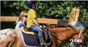  ?? CHANNEL 2 ACTION NEWS ?? Charlie, a 5-year-old with special needs, rides a horse at Rising Hope FarminMilt­on. The riding facility is part of Special Equestrian­s ofGeorgia.