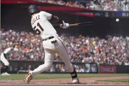  ?? JEFF CHIU — THE ASSOCIATED PRESS ?? The Giants' Luis Gonzalez hits an RBI single against the Washington Nationals during the seventh inning in San Francisco on Sunday.