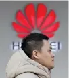  ?? REUTERS/JASON LEE ?? A MAN walks past a Huawei’s company logo outside its shop in Beijing, China, Dec. 12.