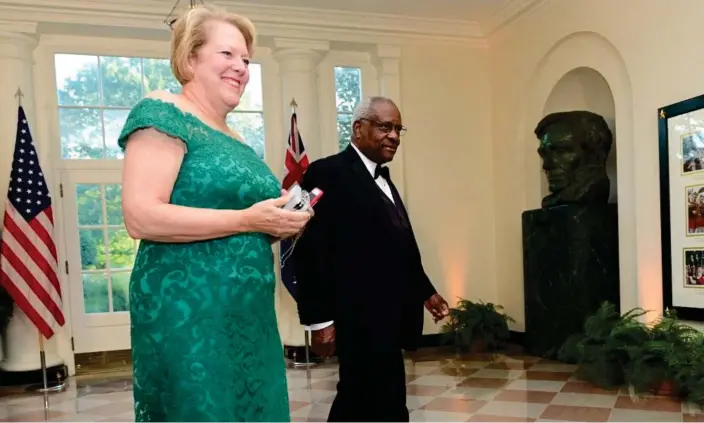  ?? Photograph: Erin Scott/Reuters ?? Ginni Thomas and her husband, Justice Clarence Thomas arrive for a state dinner at the White House in 2019.