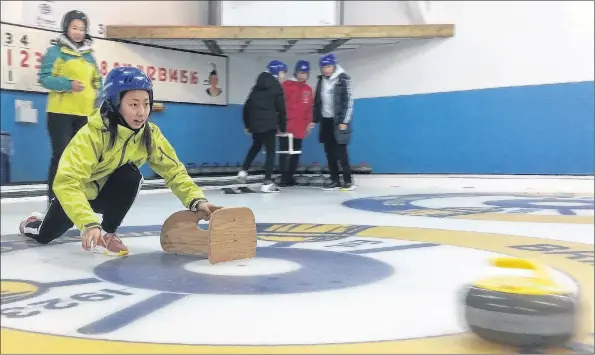  ?? LAWRENCE POWELL ?? Curling is a new sport in China, but judging from Chinese student Sally at the Bridgetown Curling Club Feb. 9, Canada might not want to let its guard down. She was a natural as Kris Humphreys taught her the basics.