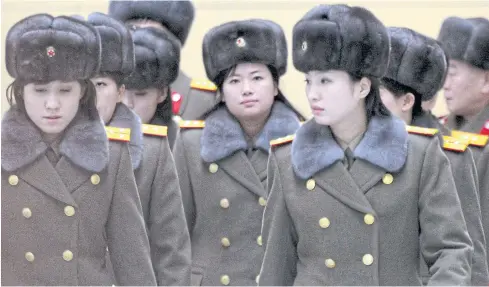  ??  ?? NO SHOW: Members of the Moranbong Band of North Korea arrive at Beijing Internatio­nal Airport on Dec 12 before departing abruptly with performing.