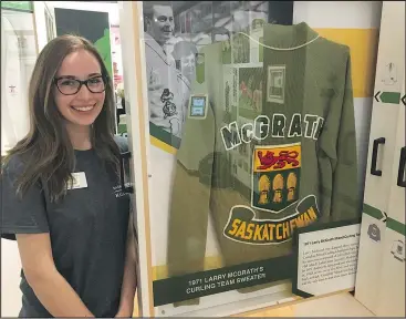  ??  ?? Heather Kelly invites curling fans to view the Hall’s displays.