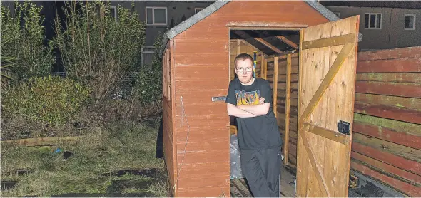  ??  ?? Jason Kerrigan, 30, at the shed from which his £500 Carrera bike was stolen on Monday night.