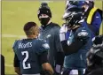  ?? DERIK HAMILTON - AP FILE ?? The Philadelph­ia Eagles’ Jalen Hurts, from left, Carson Wentz and Nate Sudfeld talk during the second half of an NFL game against the Washington Football Team on Jan. 3.