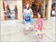  ?? Hearst Connecticu­t Media file photo ?? Olivia Keator, 8, and her mother, Julie, enjoy a day of back-to-school shopping at the Connecticu­t Post mall in Milford.