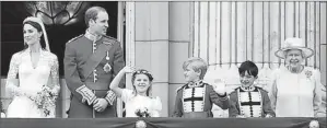  ?? By James Devaney, Filmmagic ?? April 29, 2011: Catherine and Prince William, with Margarita Armstrong-Jones, 8, Tom Pettifer, 8, William Lowther-Pinkerton, 10, and Queen Elizabeth II, on the balcony after the royal wedding.