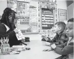  ?? NIKHINSON/AP JULIA ?? Student teacher Lana Scott teaches kindergart­ners the alphabet.