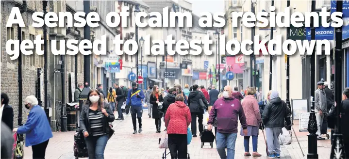  ?? Picture: Gayle Marsh ?? Shoppers in Neath town centre yesterday ahead of the introducti­on of a local lockdown at 6pm last night.