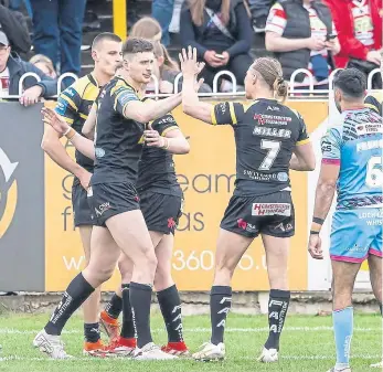  ?? ?? BRIEF RESPITE: Castleford’s Sam Wood, centre, celebrates after the Tigers grabbed a consolatio­n try through Innes Senior in the Challenge Cup defeat to Wigan yesterday.