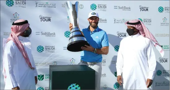  ??  ?? Dustin Johnson shows off his trophy after winning the Saudi Internatio­nal for the second time in three years