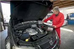  ??  ?? Amazing Auto Electric owner Greg Box checks a latemodel vehicle at the company’s Sydenham workshop.